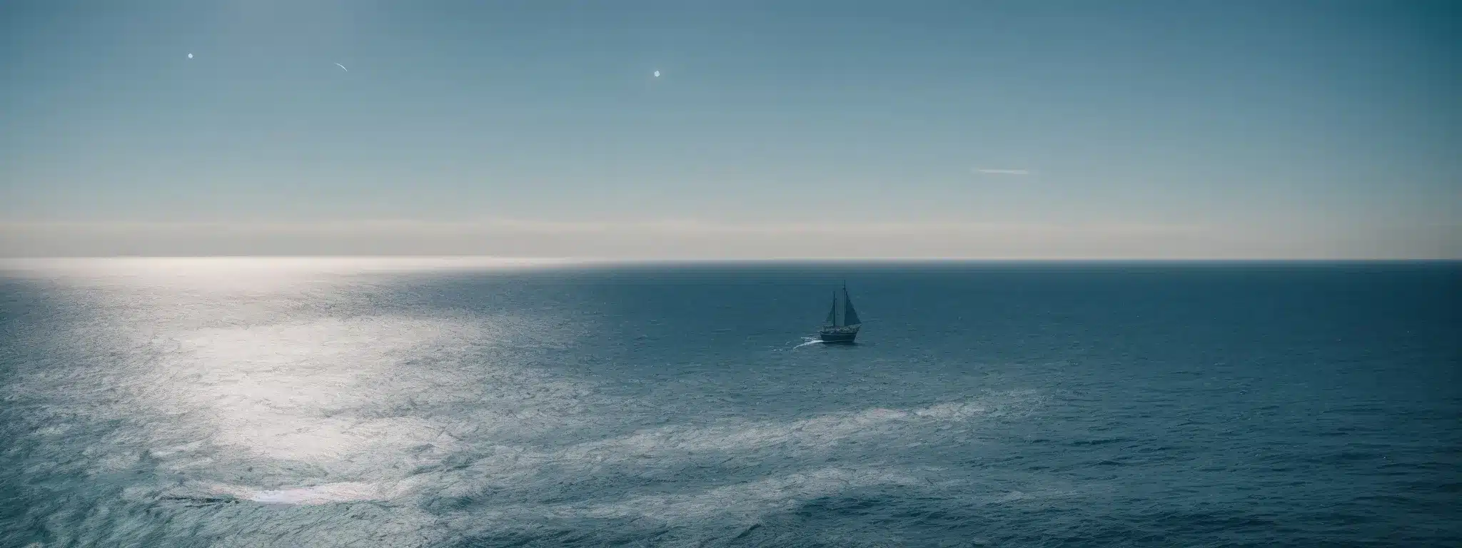 A Lone Ship Sails The Serene Blue Sea Beneath The Gleam Of A Bright Star, Embarking Towards A Horizon Of Distinct Possibility.