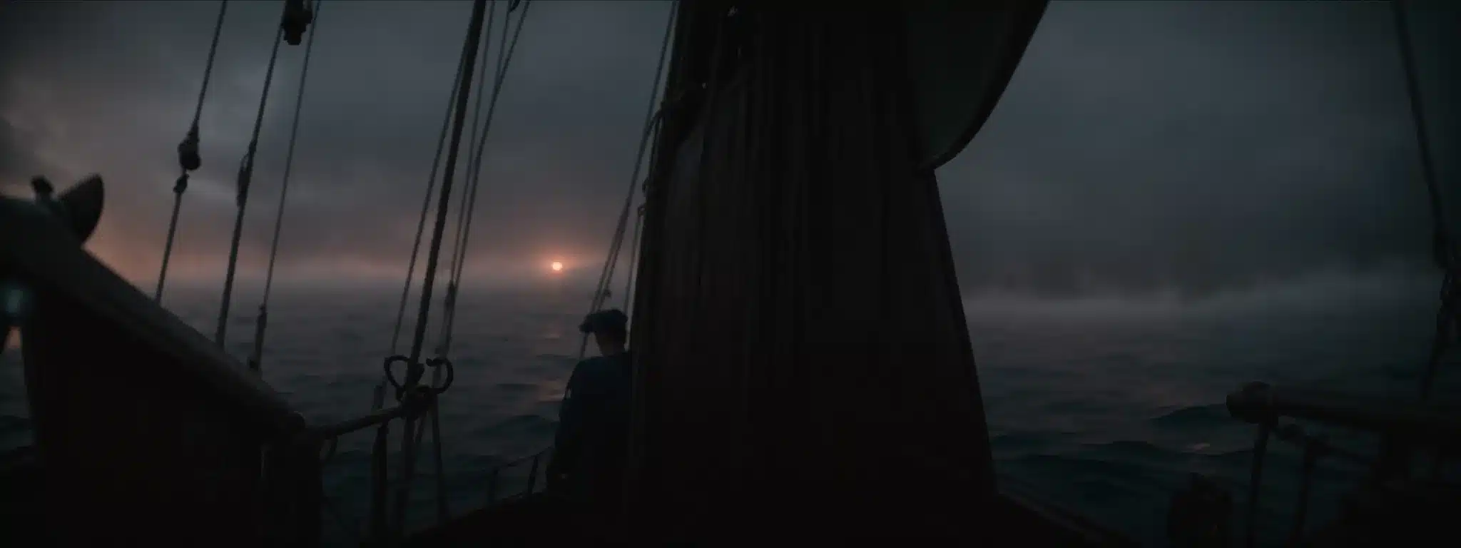 A Person Stands At The Helm Of An Old-World Sailing Ship, Navigating Through Misty Seas At Dawn.