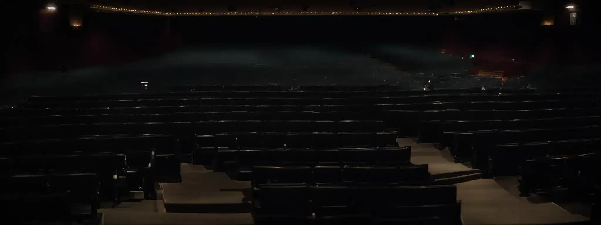A Spotlight Shining Center Stage On An Empty Theater With Rows Of Seats Facing Towards The Stage, Waiting For The Performance Of Strategy To Begin.