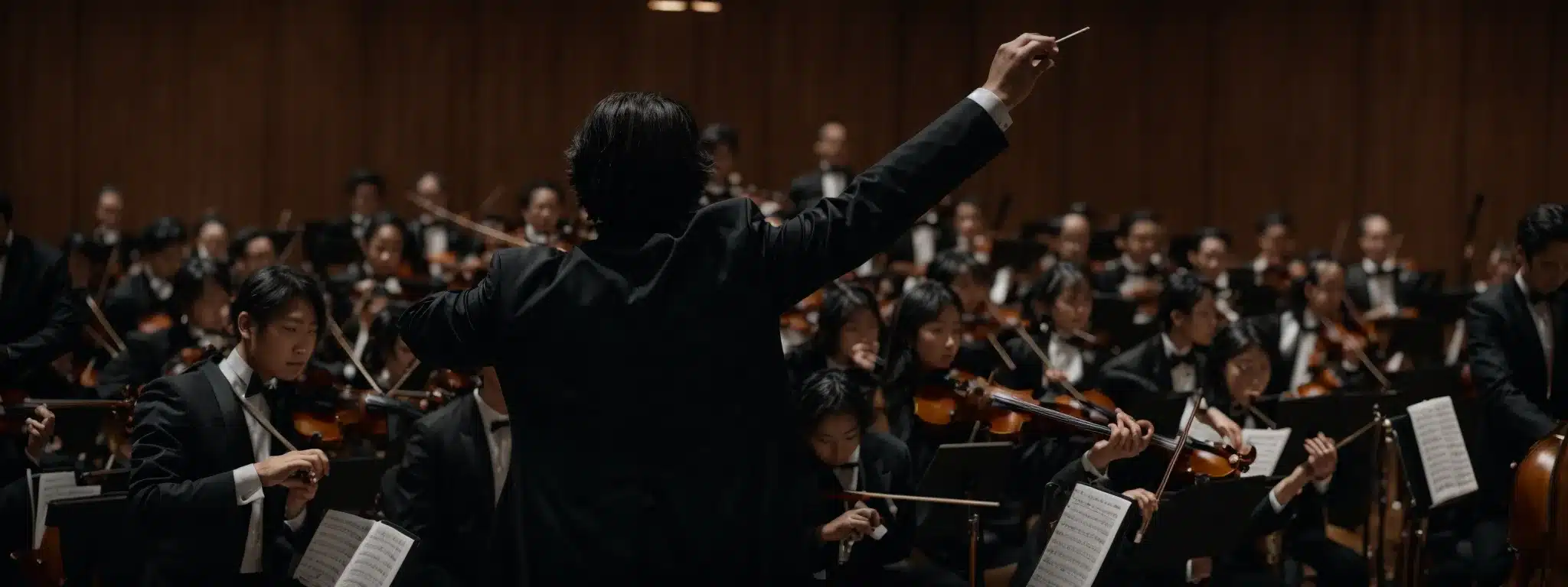 A Conductor Leading An Orchestra With Seamless Coordination And Focused Intensity.