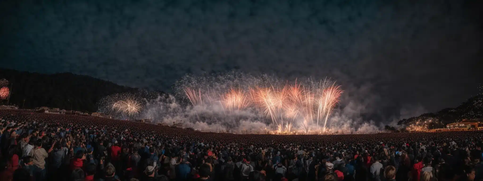 A Grand Opening Celebration With A Majestic Fireworks Display Illuminating The Sky Above A Crowd.