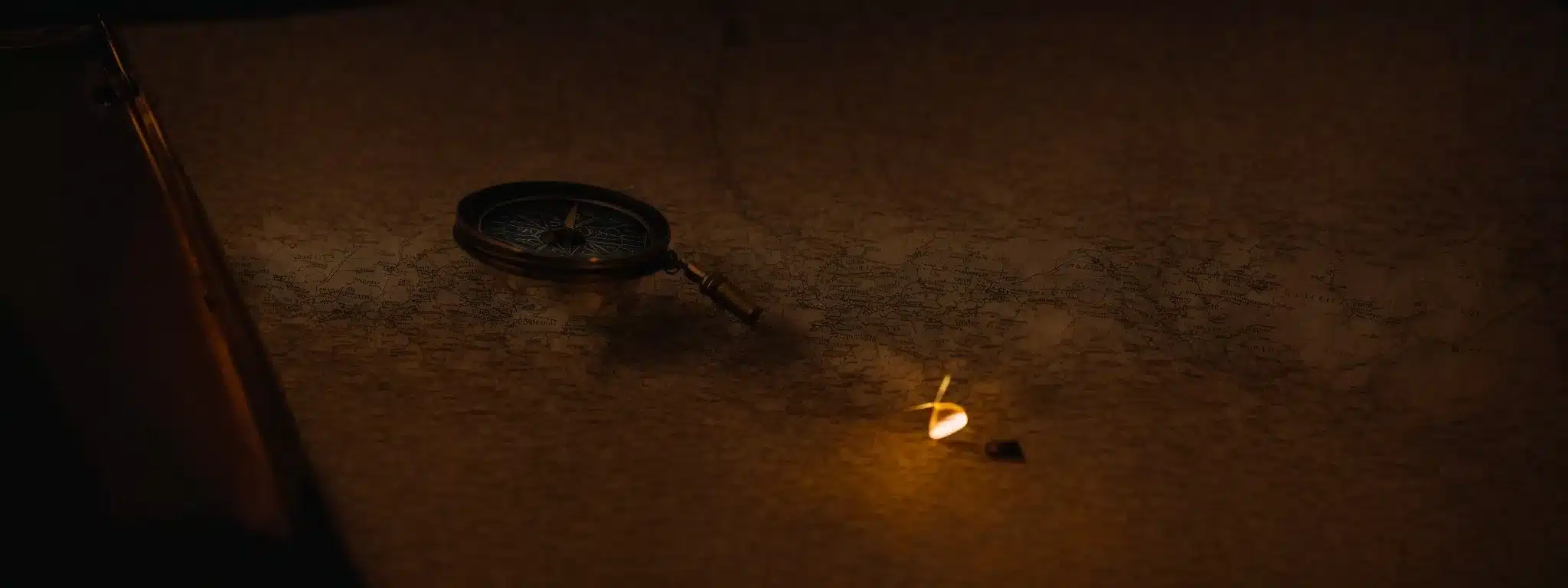 A Compass Resting On An Ancient Map Under A Soft Glowing Lantern, Symbolizing Navigational Guidance On A Strategic Journey.