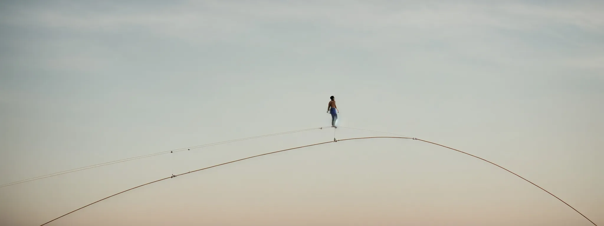 A Tightrope Walker Balances Gracefully, Scanning The Horizon As They Proceed.