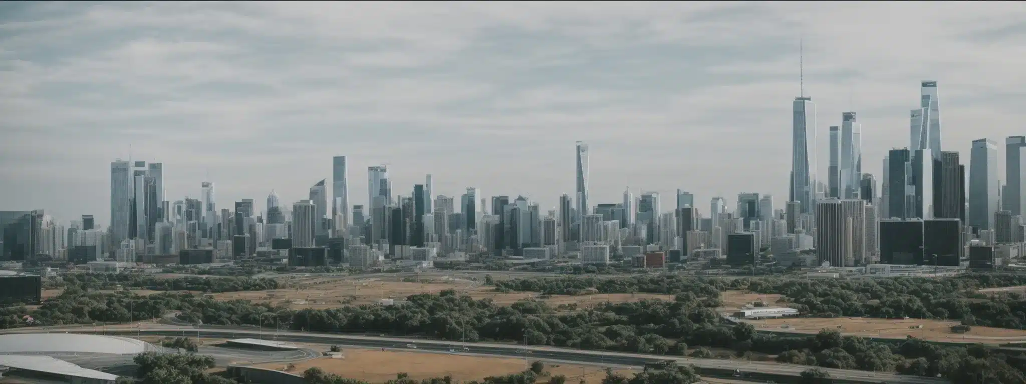 A Panoramic View Of A Clean, Modern City Skyline With Minimalistic Architecture And Wide Open Spaces.