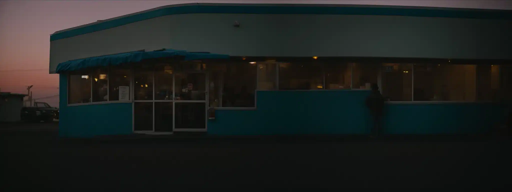 A Person Standing By A Diner'S Entrance At Twilight, Poised To Turn A Key In The Front Door.